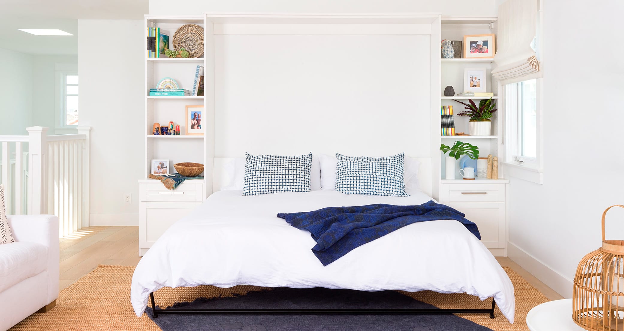 Queen wall bed with customized storage shelves and bedside cabinets by California Closets