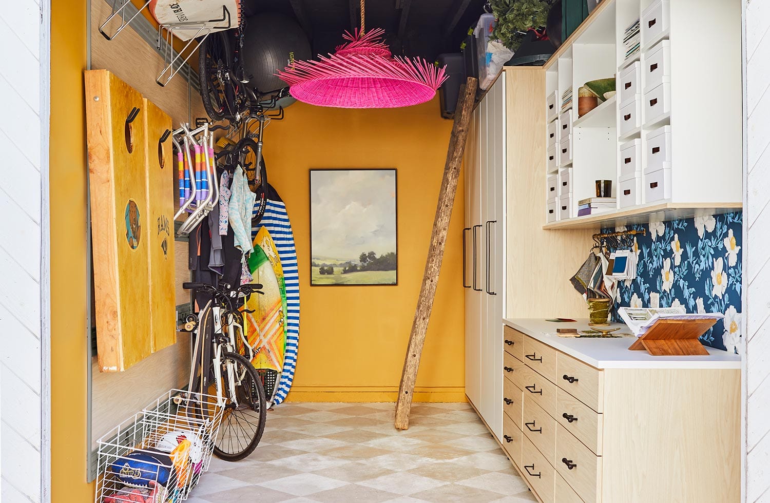 Garage storage solutions for your home with custom cabinets in a light wood finish by California Closets