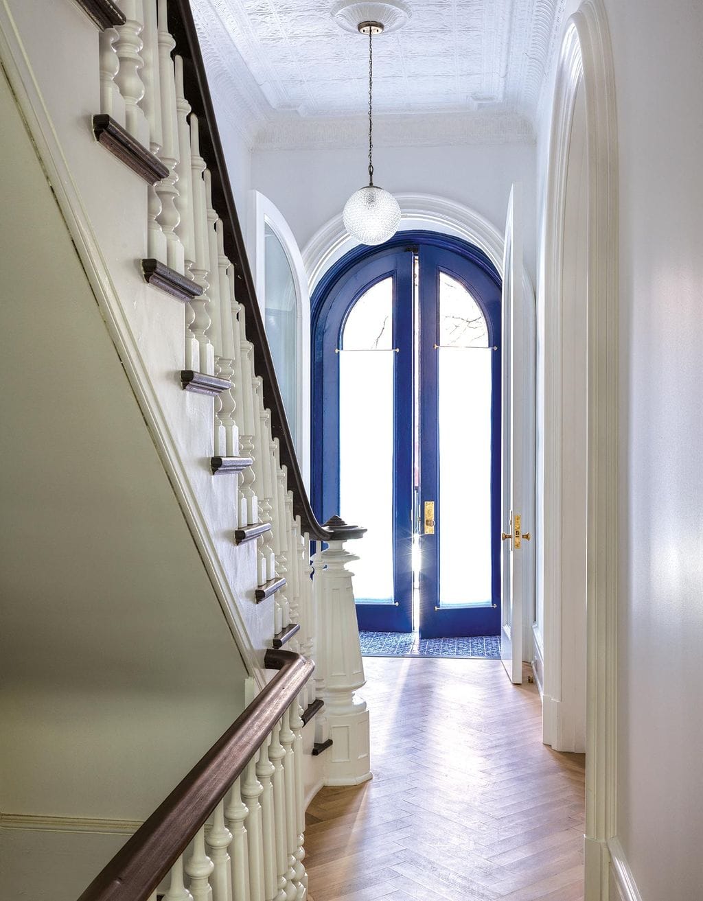 The vivid blue of the doors at the entryway of their Brooklyn home was inspired by doorways Suleika from Tunisia - Ideas of Order Magazine