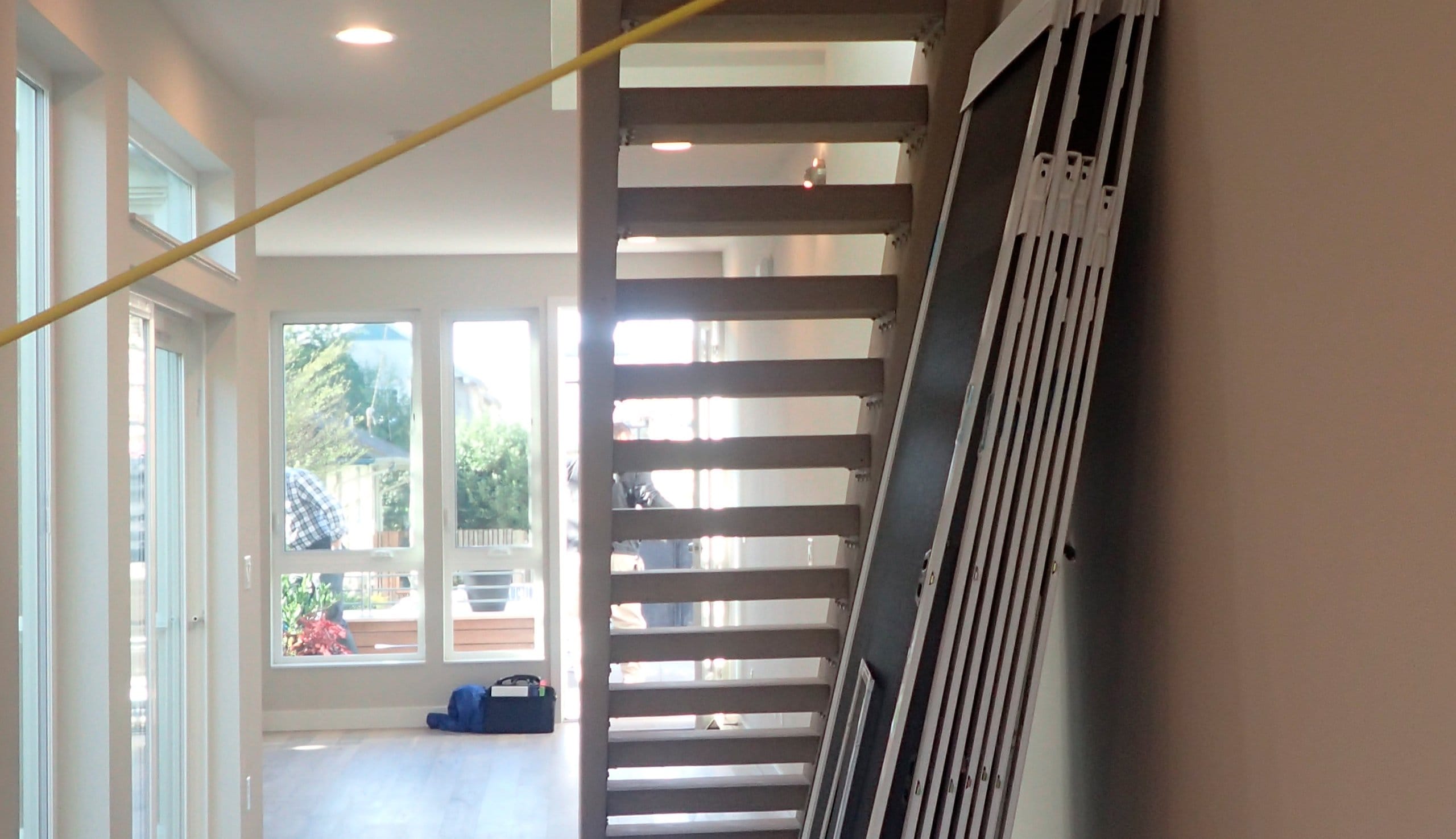 Before a custom pantry under the stairs build design to be installed by California Closets