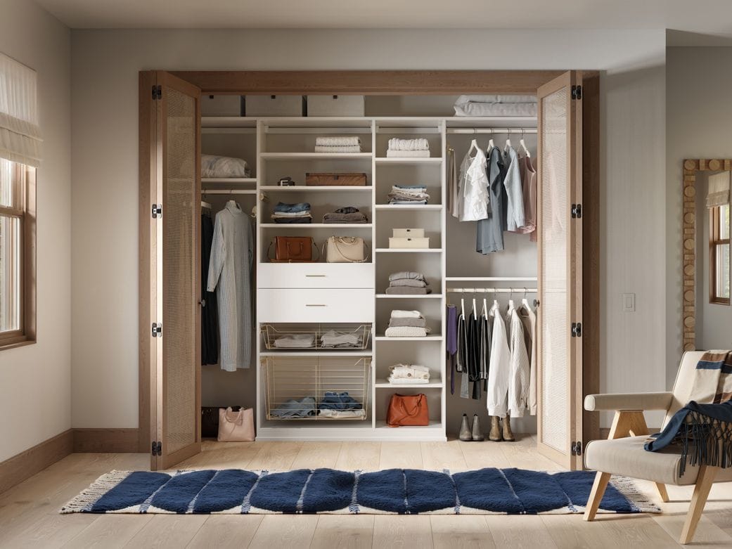 Designed with custom closet reach in design with cubbies and open shelving by California Closets